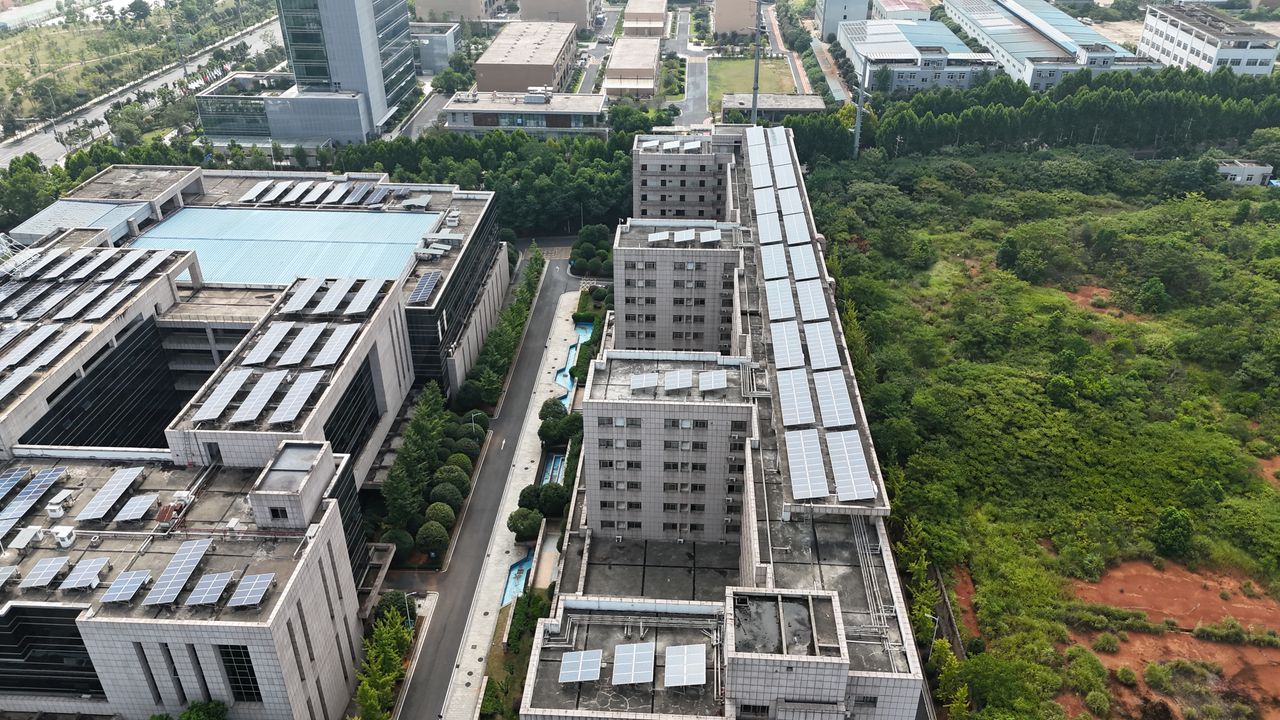 Mastering the First Impression: Your intriguing post title goes here Aerial urban landscape with solar-panel rooftops and green spaces.