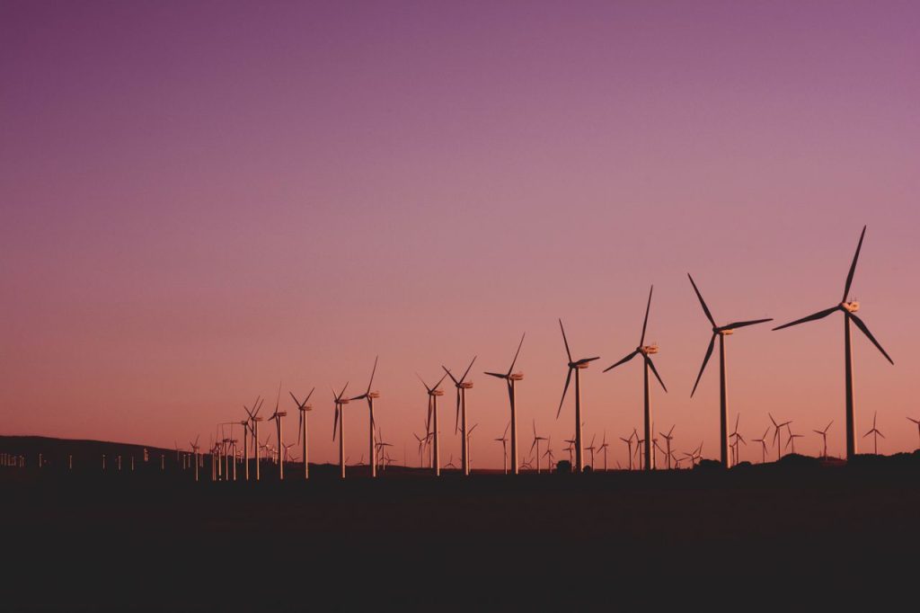 Silhouetted wind turbines at sunset in Zahara de los Atunes, Spain.